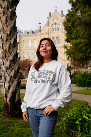 Brissa Campos Toscano stands in front of St. Louis Hall