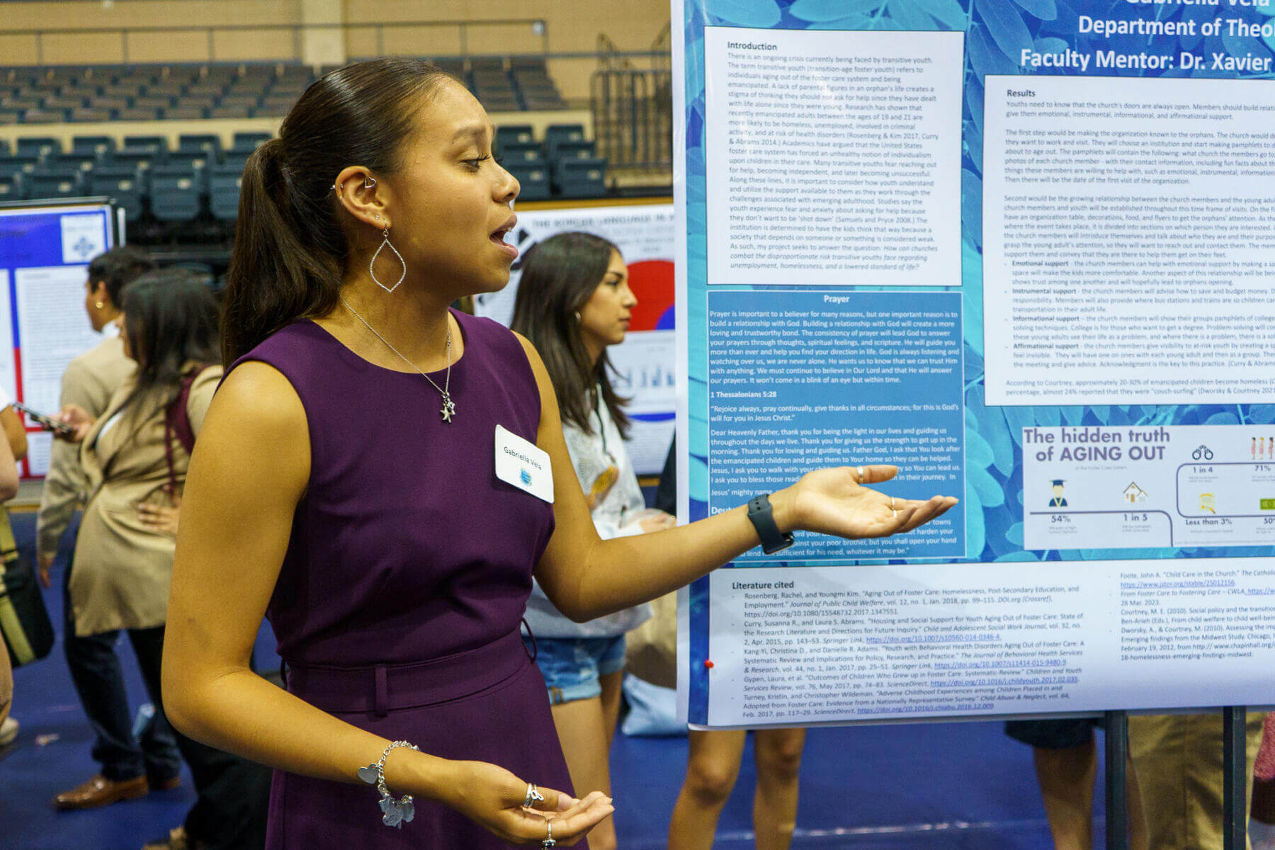 A female student presents her research during the Research Showcase.