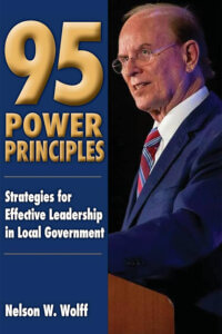 Judge Wolff stands at a podium in this cover image.