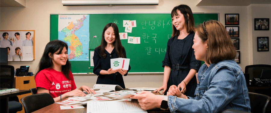 Three International students in a classroom studying together