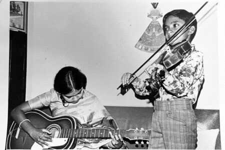 Winston Erevelles, right, plays music with his sister, Gianni Erevelles, during their childhood in India.