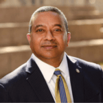 Winston Erevelles stands on the Amphitheater steps.