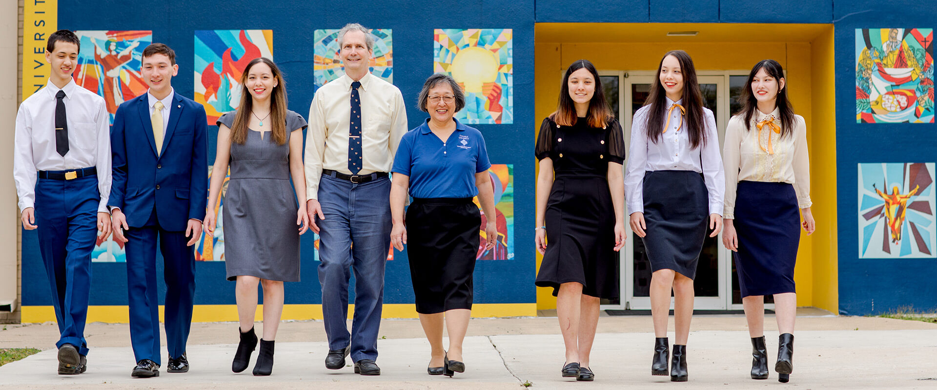 Linda Muller (center, blue shirt) and her family walk by the Catholic Artway