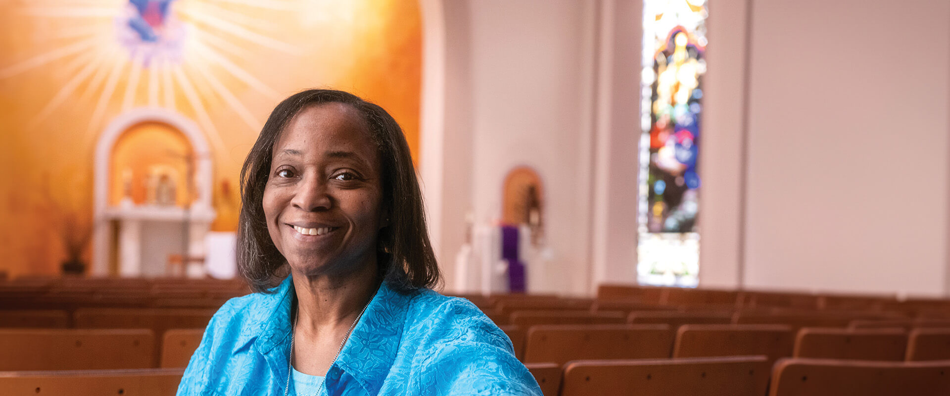Sister LaReine-Marie Mosley, Ph.D., sits in Assumption Chapel.