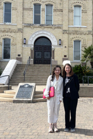 Photo shows Visiting Scholar Yun Weixiao, Law Professor at Changchun Humanities Academy in China, and Jennifer Stevenson, J.D., Assistant Dean for International Programs for the School of Law, visit in front of St. Louis Hall on the St. Mary's University campus.
