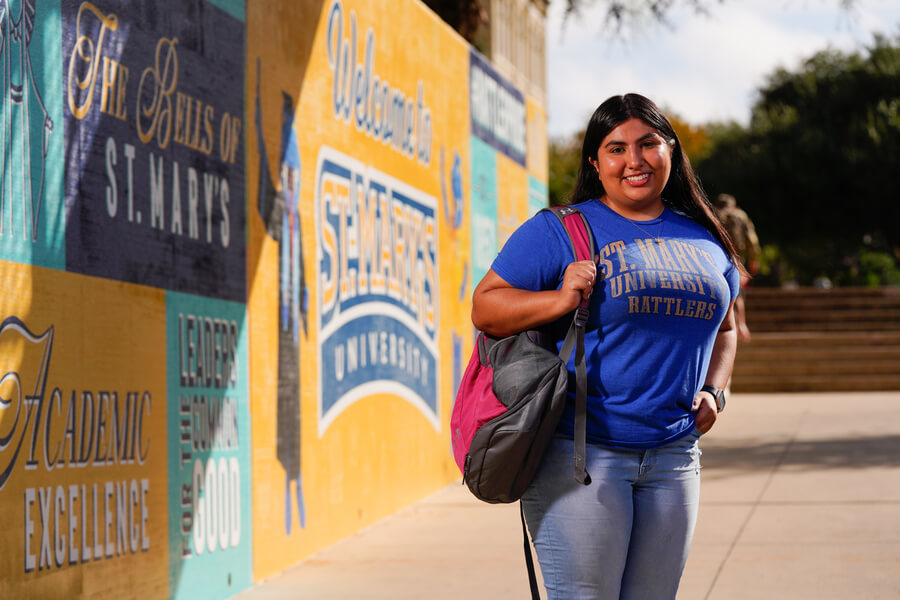 Students smiles as she walks around the St. Mary's Campus.