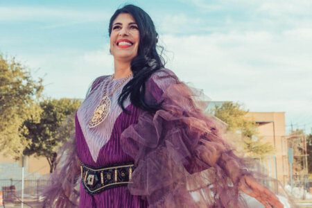  Amanda Alacron-Hunter wearing vibrant purple dress and cape she created.