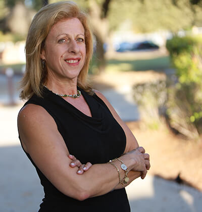 Lyda Creus Molanphy in a black shirt on the campus of St. Mary's Law.