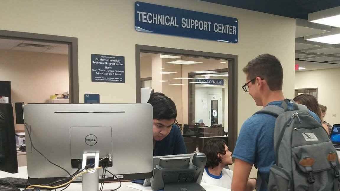 Technical Support Center (TSC) staff assists students at the help desk