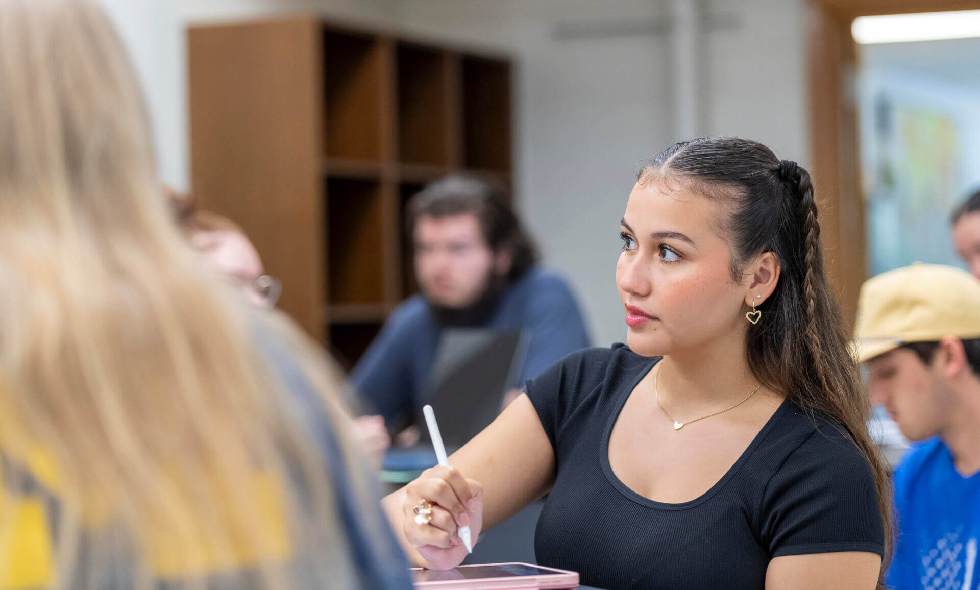 A student taking notes in a lab.