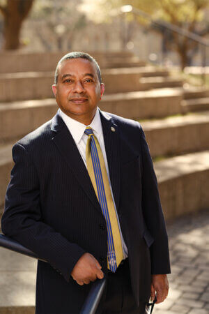 Winston Erevelles stands on the Amphitheater steps.