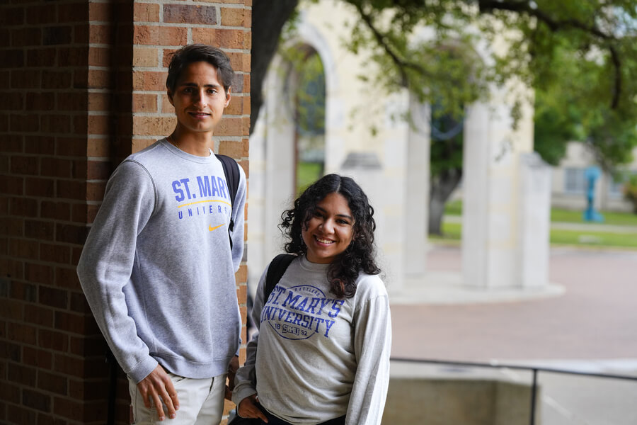 Two international students stand together smiling