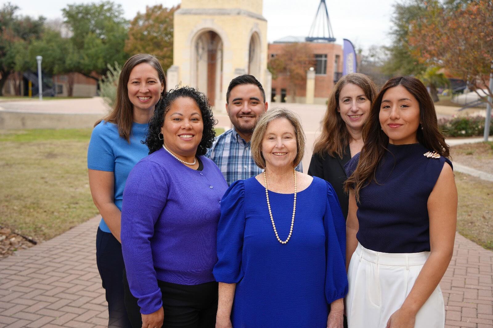 Center for International Programs team group photo outside on a sunny day by the St. Mary's University Bell Tower