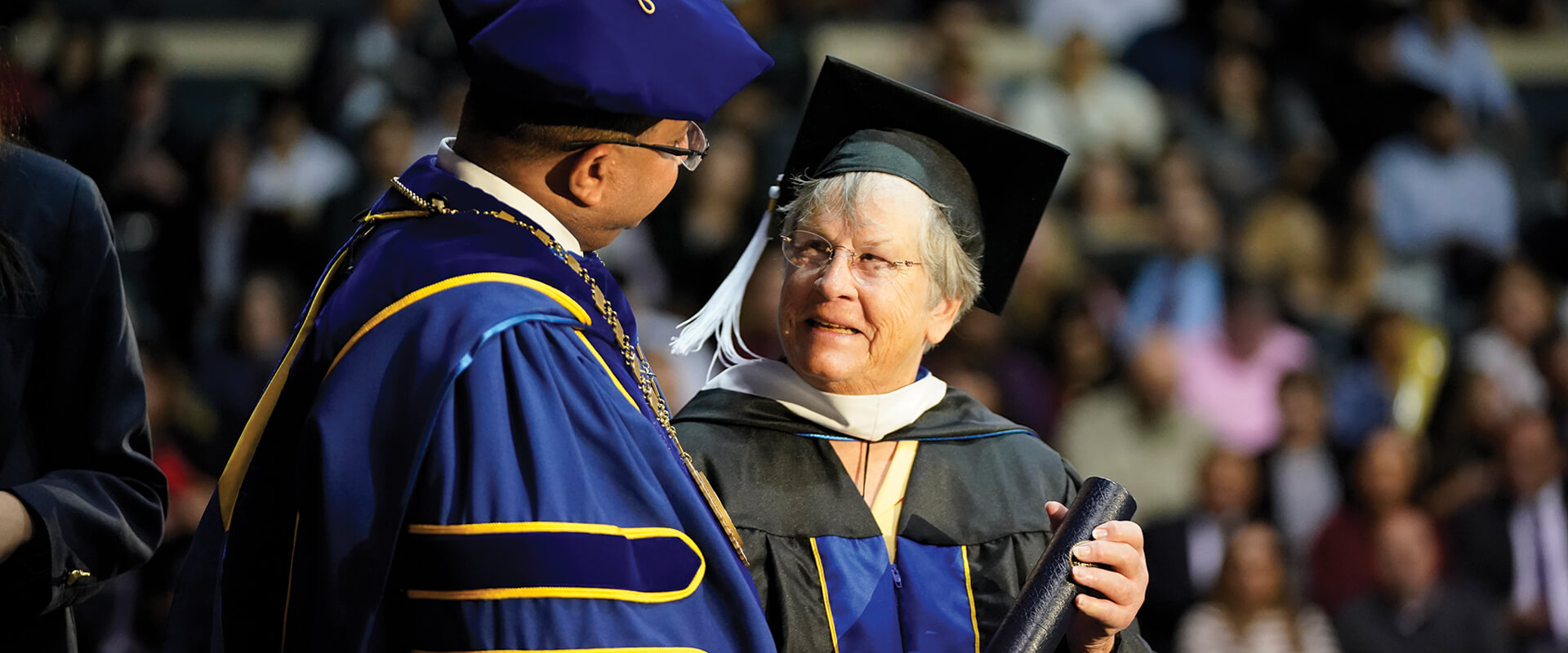 Patricia Howey, who is the first graduate to earn a Master of Jurisprudence with a concentration in Special Education Advocacy, accepts her degree on stage during Fall 2024 Law Commencement.