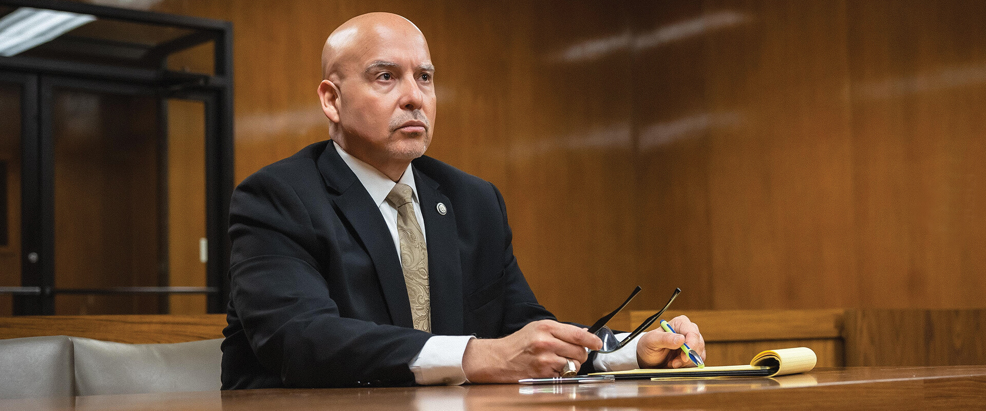 Carlos A. García, who earned his J.D. in 2005, sitting at a table in a courtroom.