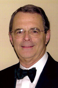 Bennie Walter Bock II in a black and white tuxedo with black bowtie.