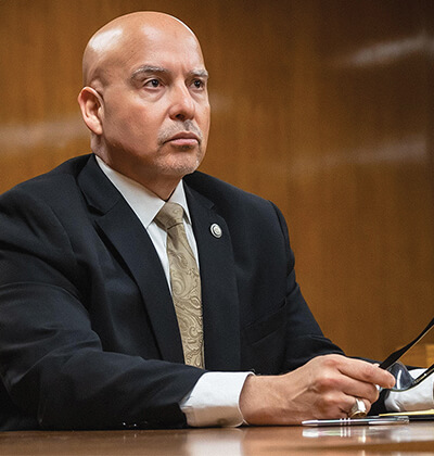 Carlos A. García, who earned his J.D. in 2005, sitting at a table in a courtroom.