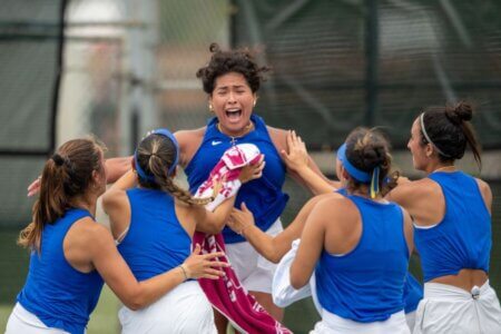 The Rattler Women's Tennis team celebrates their win.