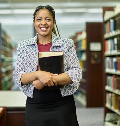 Daeja Hall, who will earn her J.D. on May 17, 2025, is photographed in the Sarita Kenedy East Law Library on campus.