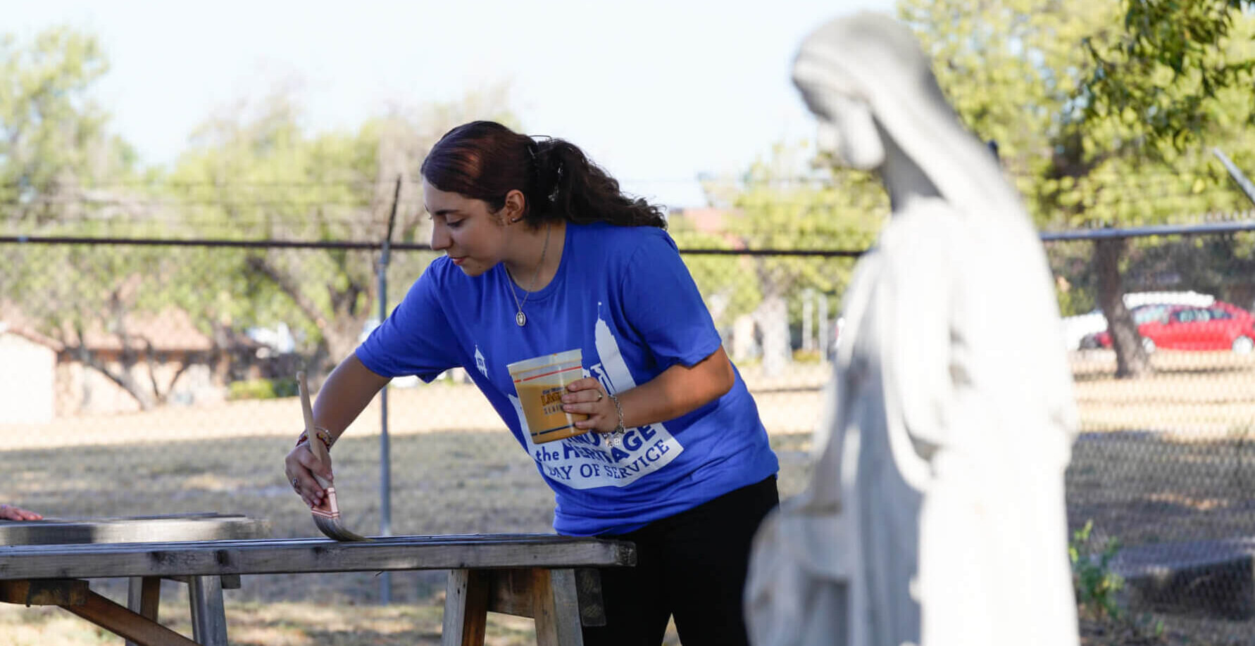 A female works hard to fix a table for the community during Coninueing the Heritage