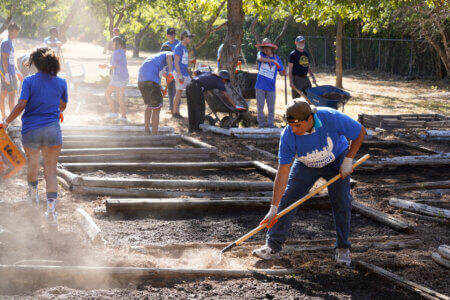 Students help tend to gardens during Continuing the Heritage