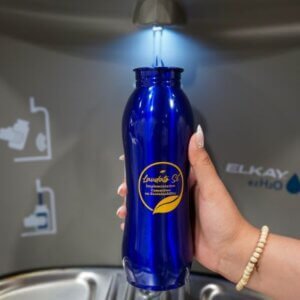 A staff member fills up her Laudato Si' water bottle at a new water bottle refilling station.