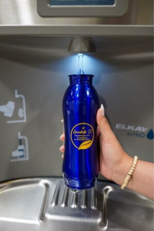 A staff member fills up her Laudato Si' water bottle at a new water bottle filling station on the third floor of St. Louis Hall, a project proposed by Professor of Political Science Arturo Vega, Ph.D.