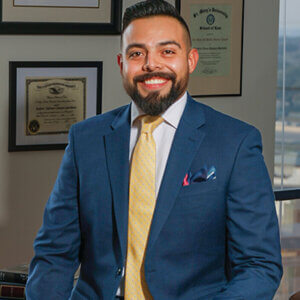 Roberto Campos, who earned his Master of Laws, is in his office. He