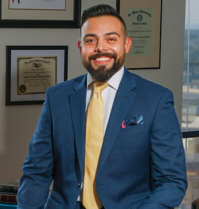 Roberto Campos, who earned his Master of Laws, is in his office. He