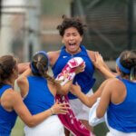 The Rattler Women's Tennis team celebrates their win.