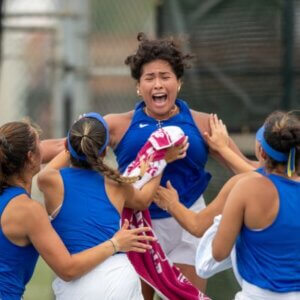 The Rattler Women's Tennis team celebrates their win.