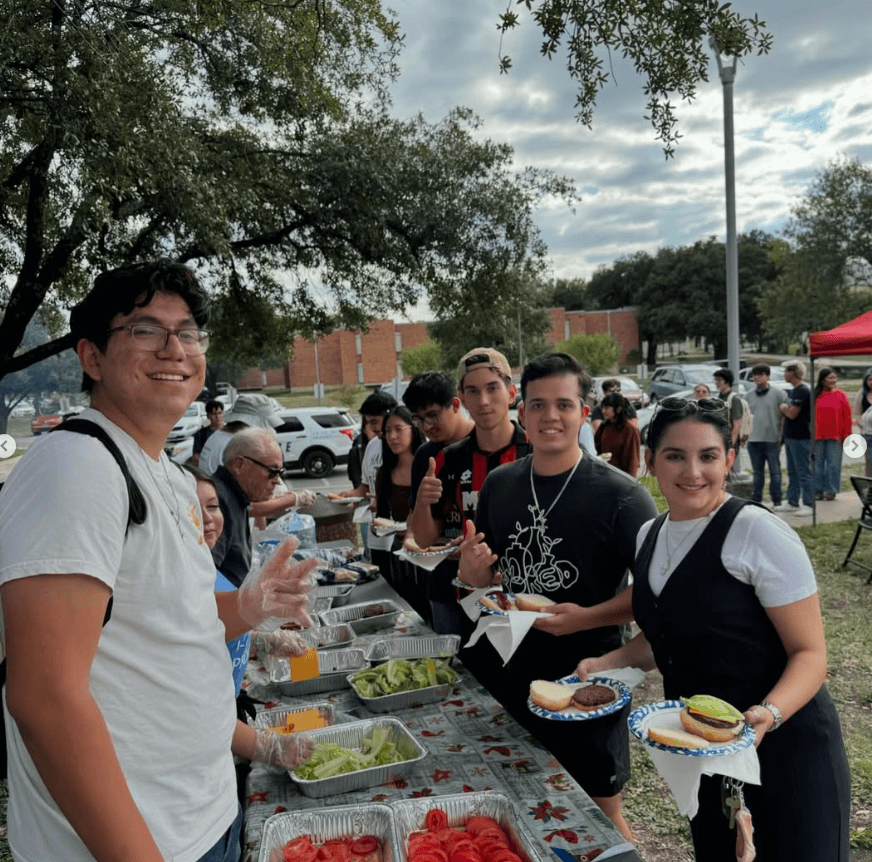 Students gather with the Marianist Brothers as they enjoy burgers and hotdogs during Burgers with the Brothers.