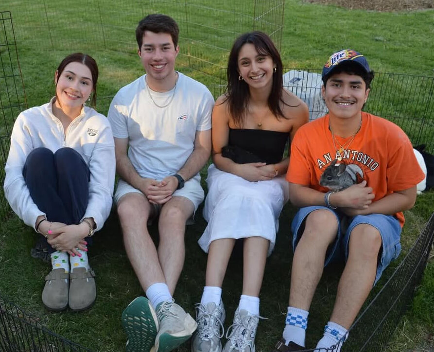 Students sit in the field