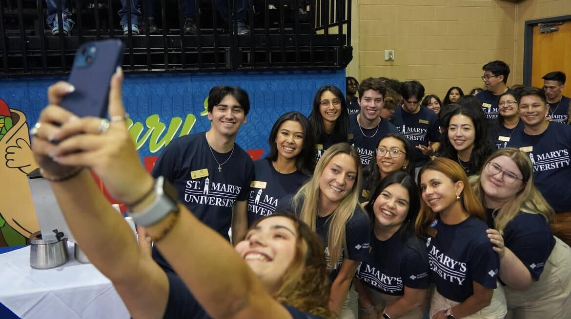Zaragoza student takes a picture of her group on her phone.