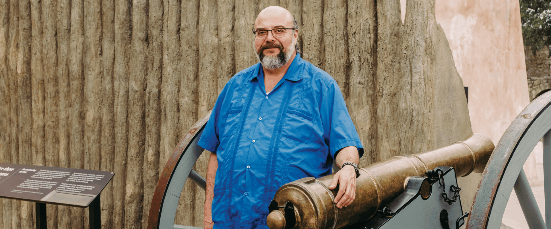 Ernesto Rodriguez III stands near a reproduction of a six-pounder cannon at the new Mission Gate and Lunette exhibit, an interpretive representation of the main gate of the mission-fort that sits in front of the Alamo Church.