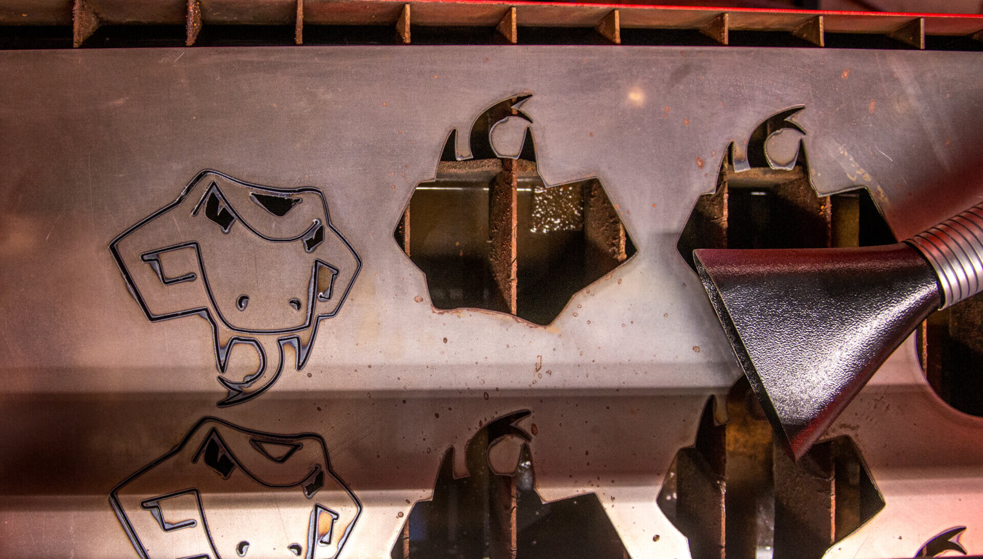 Students cut out an image of Rattler Man using the Plasma Cutter in the Engineering Room.