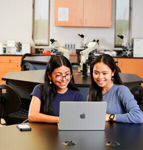Two students explore the new Master of Science Medical Genomics program online