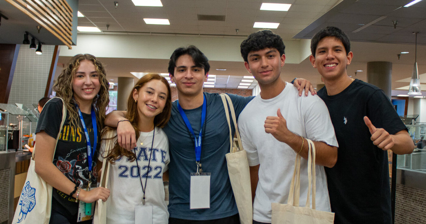 International students take a group photo in the Diamondback Cafe.