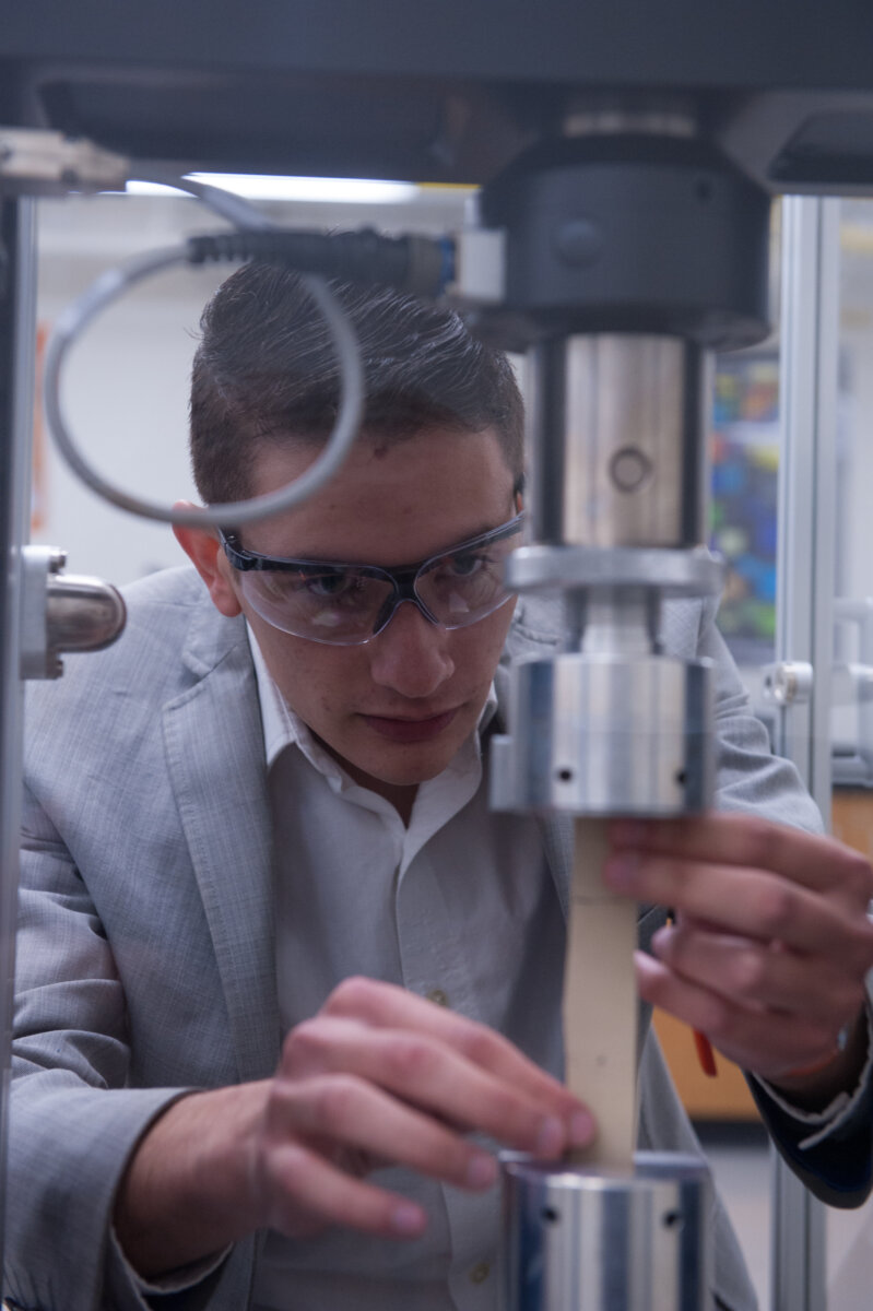 SET student examines machine.