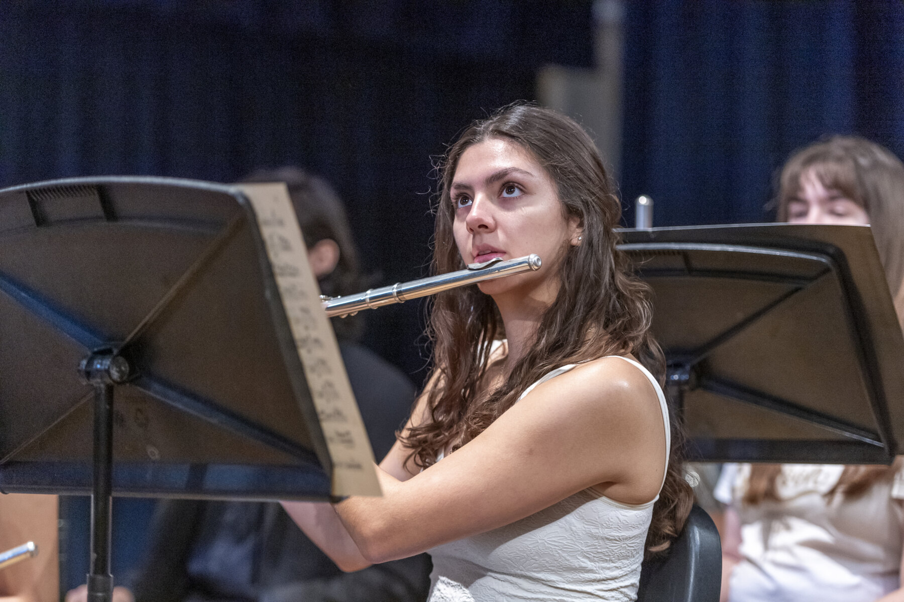 Female student plays a flute.