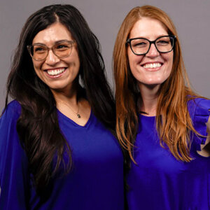 Gaby Aquino, Ph.D. (B.A. ’19), left, wears blue for a photoshoot with Professor of Psychology Jillian Pierucci, Ph.D.
