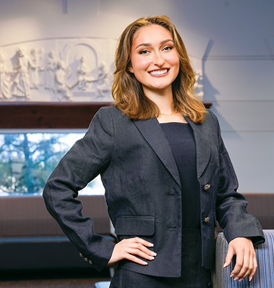 J.D. student Emily Trollinger is standing in the Law Commons in the Sarita Kenedy East Law Library on campus.