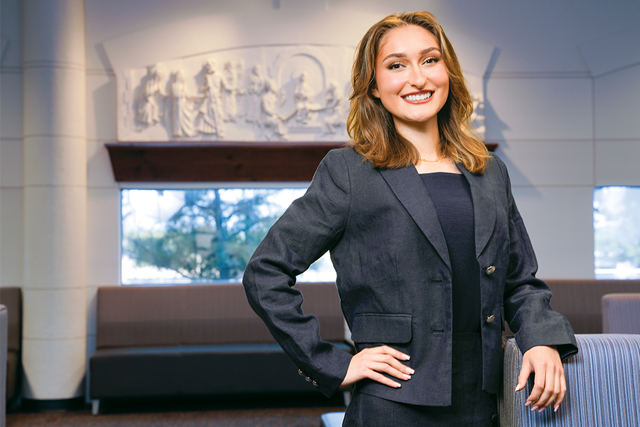 J.D. student Emily Trollinger is standing in the Law Commons in the Sarita Kenedy East Law Library on campus.