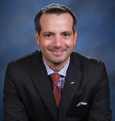 Professional photo of Franklin Hopkins in dark suit and red tie.