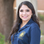 J.D. student Lauren Cortez in a blue National Team polo shirt.