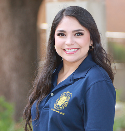 J.D. student Lauren Cortez in a blue National Team polo shirt.