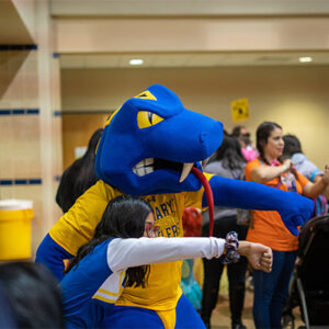 Rattler Man poses with a student during the annual Boo Bash