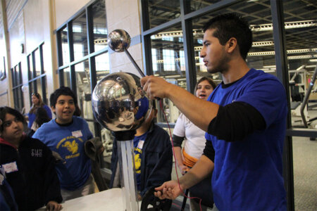 A student from St. Mary's University demonstrates a science experiment.