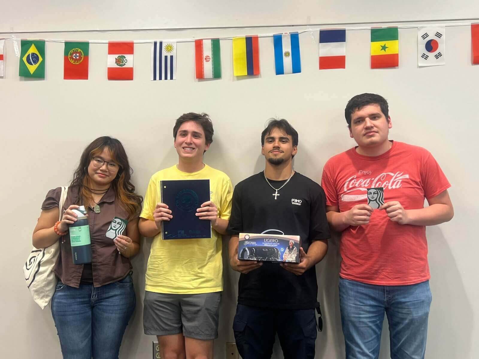 Students hold up their Rattler themed prizes.