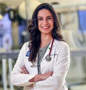 Alex McLennan stands in the DeBakey Library and Museum at the Baylor College of Medicine.